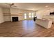 Spacious living room with fireplace, modern ceiling fan, wood floors, and access to the kitchen and backyard at 282 Trescott St, Smithfield, NC 27577