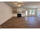 Bright and airy living room with hardwood floors, a ceiling fan, a fireplace with custom shelving, and plenty of natural light at 282 Trescott St, Smithfield, NC 27577