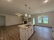 The living room and kitchen offer an open layout, stainless appliances, and a cozy fireplace at 282 Trescott St, Smithfield, NC 27577