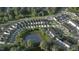 Community aerial view showcasing modern townhomes, green spaces, streetscapes, and a serene pond at 815 Central Park Dr, Knightdale, NC 27604