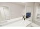 Modern bathroom with a large mirror, spacious vanity and shower-tub combination at 815 Central Park Dr, Knightdale, NC 27604