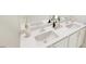 Bathroom featuring double sinks with white countertops, modern faucets, and a large mirror at 815 Central Park Dr, Knightdale, NC 27604