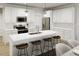 Modern kitchen featuring white cabinetry, stainless steel appliances, a kitchen island with seating at 815 Central Park Dr, Knightdale, NC 27604