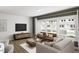 Bright living room with large windows, modern furniture, hardwood floors and recessed lighting at 815 Central Park Dr, Knightdale, NC 27604