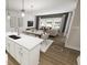 Open-concept living space with dining area, kitchen island, and modern living room at 815 Central Park Dr, Knightdale, NC 27604
