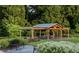 Inviting outdoor pavilion with beautiful wooden beams, a seating area, and lush green landscaping at 815 Central Park Dr, Knightdale, NC 27604