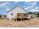Back exterior view featuring the wood porch of this house at 30 Tee Dr, Selma, NC 27576