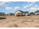 Spacious backyard with back porch overlooking the new home construction at 30 Tee Dr, Selma, NC 27576