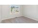 Cozy bedroom with neutral tones, window, and carpeted floor at 30 Tee Dr, Selma, NC 27576