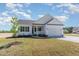 Inviting single-story home showcases a well-manicured lawn and a classic white exterior at 30 Tee Dr, Selma, NC 27576