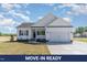 Charming one-story home features a white exterior, black shutters, and an attached two-car garage at 30 Tee Dr, Selma, NC 27576