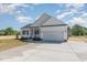 Attractive one-story home boasts a wide driveway, white exterior, and a convenient two-car garage at 30 Tee Dr, Selma, NC 27576