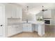 Bright kitchen boasts white cabinetry, granite countertops, and modern fixtures at 30 Tee Dr, Selma, NC 27576