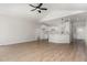 Spacious living area adjoining kitchen features hardwood floors, a ceiling fan, and an open layout at 30 Tee Dr, Selma, NC 27576