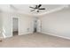 Spacious main bedroom with neutral colors, ceiling fan, and walk in closet access at 30 Tee Dr, Selma, NC 27576
