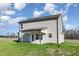 Picture of the back of the home showing light vinyl siding and covered patio with a large yard at 300 Tuscany Cir, Princeton, NC 27569
