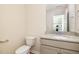 Half bathroom featuring stylish granite countertops, a modern sink, and a white toilet at 300 Tuscany Cir, Princeton, NC 27569