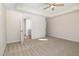 Neutral bedroom with large windows, ceiling fan, and an ensuite bathroom at 300 Tuscany Cir, Princeton, NC 27569