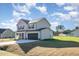 Side view of a charming home with a two-car garage and neatly landscaped surroundings at 300 Tuscany Cir, Princeton, NC 27569
