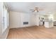 Bright, open-concept living room with wood floors and a modern electric fireplace feature at 300 Tuscany Cir, Princeton, NC 27569