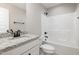 A full bathroom features granite countertops, white cabinets, and a tub-shower combination at 303 E Pope Ave, Kenly, NC 27542