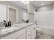 A bathroom is equipped with double sinks, granite countertops, shower-tub combo, and vinyl flooring at 303 E Pope Ave, Kenly, NC 27542