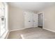 This bedroom has a double door closet, neutral paint and carpet, and bright light at 303 E Pope Ave, Kenly, NC 27542