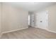 This carpeted bedroom has neutral paint, a double door closet, and a doorway to an en-suite bathroom at 303 E Pope Ave, Kenly, NC 27542