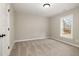 This carpeted bedroom has a window, neutral paint, and black door hardware at 303 E Pope Ave, Kenly, NC 27542