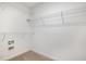A walk-in closet with white shelving and neutral carpet at 303 E Pope Ave, Kenly, NC 27542
