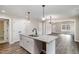 Stylish kitchen island with granite counters, modern faucet, and seamless access to adjacent living spaces at 303 E Pope Ave, Kenly, NC 27542