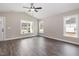 Inviting living room boasts hardwood floors, neutral walls, and plenty of sunlight through several windows at 303 E Pope Ave, Kenly, NC 27542