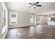 Bright living room features hardwood floors, vaulted ceilings, and ample natural light from large windows at 303 E Pope Ave, Kenly, NC 27542