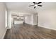 Open-concept living area with hardwood floors and seamless transition to the modern kitchen and dining space at 303 E Pope Ave, Kenly, NC 27542