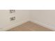 Unfinished basement space with carpet, ready for customization, and featuring hookups for the washer and dryer at 307 E Pope Ave, Kenly, NC 27542