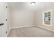 A calm bedroom with beige carpet and natural light from the window at 307 E Pope Ave, Kenly, NC 27542