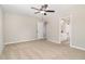 Spacious bedroom with plush carpeting, ceiling fan, and en suite bathroom with white cabinets and granite counters at 307 E Pope Ave, Kenly, NC 27542
