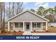 Charming home featuring a covered front porch and neatly landscaped front yard at 307 E Pope Ave, Kenly, NC 27542