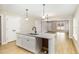 Kitchen island with granite counters, stainless steel sink, and views to the living area at 307 E Pope Ave, Kenly, NC 27542