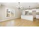 Eat-in kitchen with white cabinetry, granite counters, and modern lighting fixtures at 307 E Pope Ave, Kenly, NC 27542