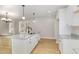 Kitchen island with granite counters, stainless steel sink, and pendant lighting at 307 E Pope Ave, Kenly, NC 27542