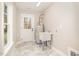 Bright laundry room featuring a utility sink, water heater, and stylish tile flooring, with a window offering natural light at 307 E Pope Ave, Kenly, NC 27542