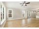 Bright living room featuring large windows, vaulted ceiling, and wood-look flooring at 307 E Pope Ave, Kenly, NC 27542