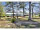Exterior view of the back of the home showing a deck and mature trees at 309 14Th St, Butner, NC 27509
