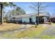 This property features a lengthy, single-story design, a gravel driveway, and a charming screened porch at 309 14Th St, Butner, NC 27509