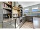 The updated kitchen boasts built-in bookshelves and stainless steel appliances at 309 14Th St, Butner, NC 27509