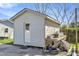 Exterior view of the backyard outbuilding with stacked building materials at 309 14Th St, Butner, NC 27509