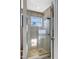 Bathroom featuring a tiled shower with a glass door and a window at 309 14Th St, Butner, NC 27509