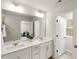 Bright bathroom with double sinks, mirror, and natural light at 309 Millennium Dr, Pittsboro, NC 27312