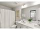 Bright bathroom featuring double sinks and framed mirror at 309 Millennium Dr, Pittsboro, NC 27312